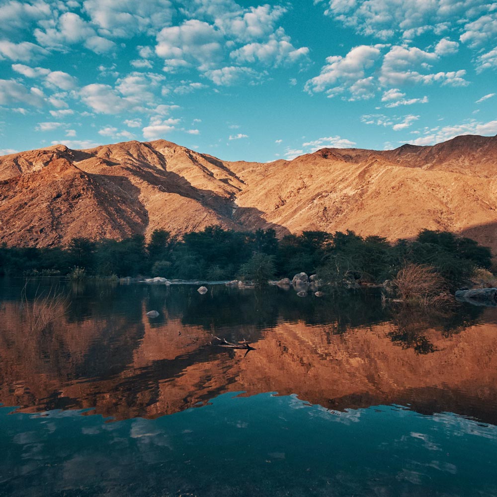 river with mountain reflection